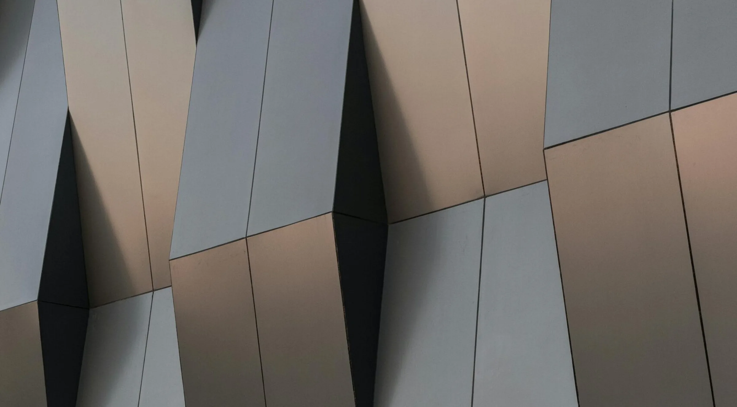Angular metal facade above a concrete base