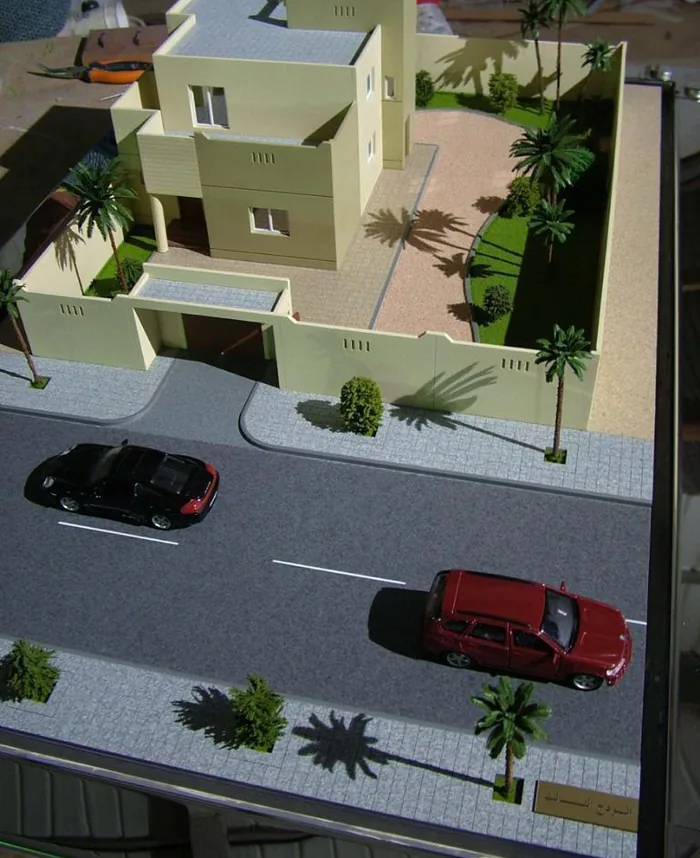 Scale model of a luxury villa with lit windows