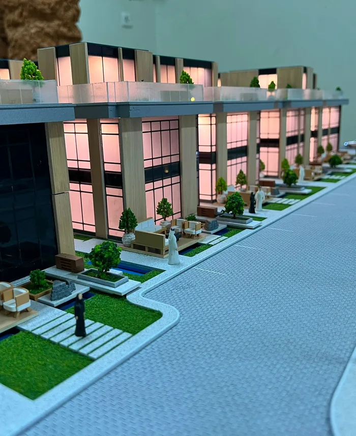 Street-level view of a lit townhouse model