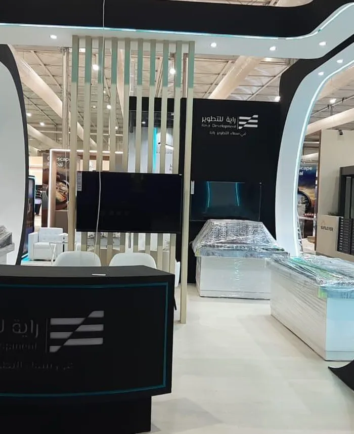 Raya Development exhibition booth with a curved black and white frame