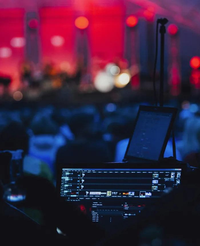 Lighting and video control desk facing a lit stage